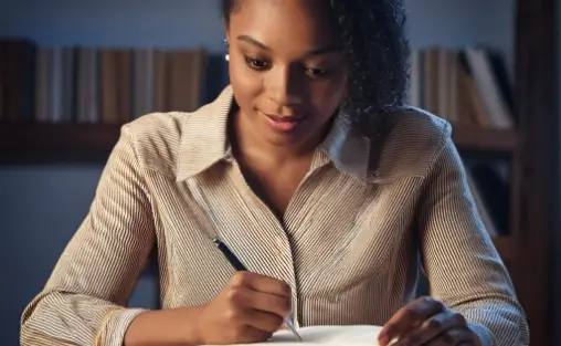 A woman writing a document for grants